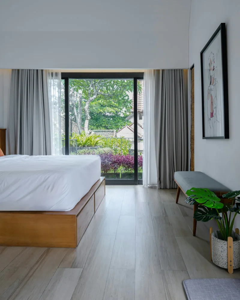 Bright bedroom with large window and garden view